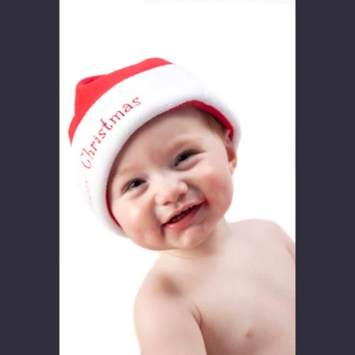 Baby wearing Santa hat during Christmas photoshoot