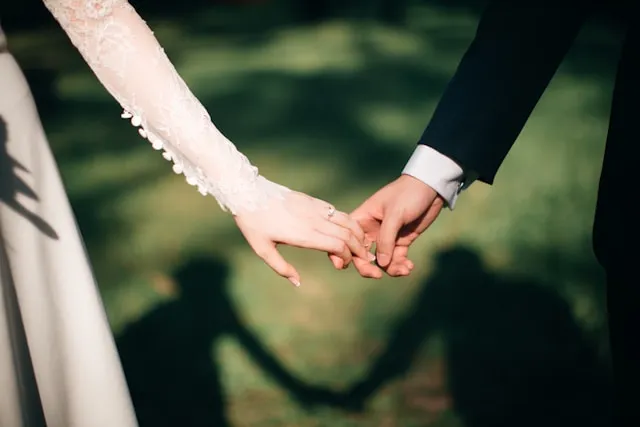 Bride and groom holding hands during wedding ceremony